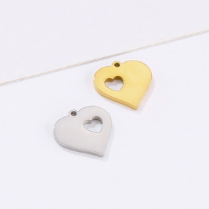 Minimalist heart-shaped hollow metal pendants in gold and silver finish on white background