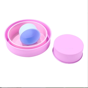 Detailed view of pink and blue round silicone cake molds in various nesting sizes