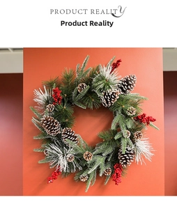 Close-up of Christmas wreath with snowy pine needles, pine cones and red berries