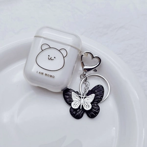 Detail of AirPods case with bear print and black resin butterfly metal keychain