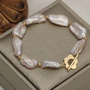 Baroque freshwater pearl bracelet with golden flower toggle clasp on jewelry box