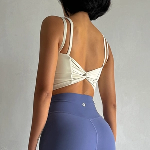 Cross-back off-white sports bra and blue high-waisted leggings yoga set back view