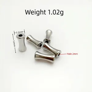 Detailed macro view of 5 polished stainless steel hourglass beads for jewelry making