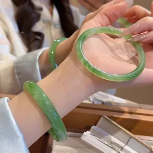 Minimalist emerald green resin bangle with translucent jade texture for a vintage look