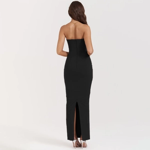 Rear view of sleek black off-shoulder knitted maxi dress with stylish back hem slit detail