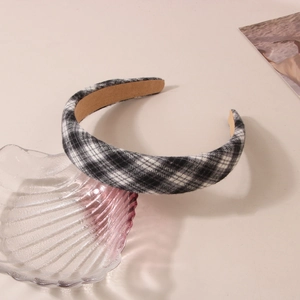 Close-up of black and white plaid fabric headband with a stylish retro sponge padded design