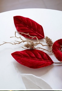 Macro detail of red velvet Christmas flower with golden pinecones and festive glitter