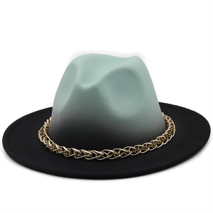 Detail of gradient mint green to black wool fedora hat with chunky gold chain decoration