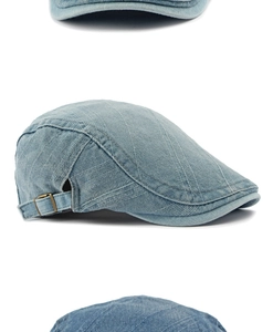 Detail view of washed blue denim beret hat with adjustable metal side buckle and texture