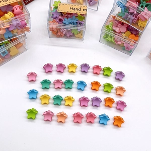 Macro view of assorted colorful star-shaped matte hair mini claws for little girls