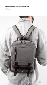 Detail view of washed canvas backpack with leather straps and front zipper pocket