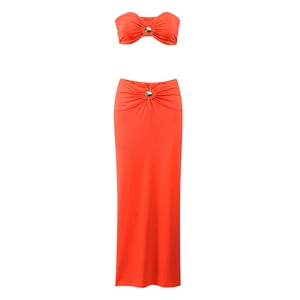 Detail of orange two-piece set featuring pleated tube top and skirt with metal ring buckles