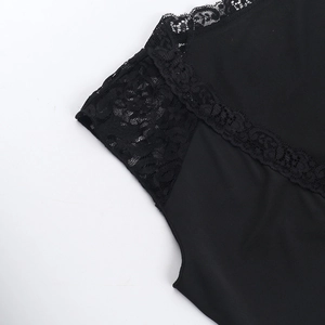 Close-up of black floral lace trim and plain fabric on a street style tank top