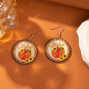 Leopard pumpkin and sunflower round earrings with hello fall text on orange background