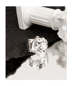Detail shot of silver irregular textured ring with lava surface on dark stone and mirror