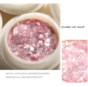 Macro detail of pink aurora opal nail glitter flakes in a clear jar for nail art design