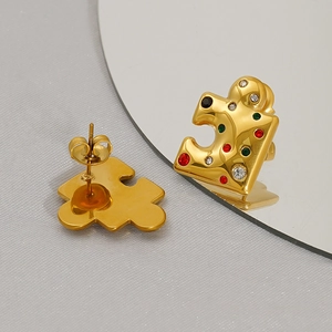 Fashion puzzle earrings in 18K gold finish with colorful zircons on a gray fabric background