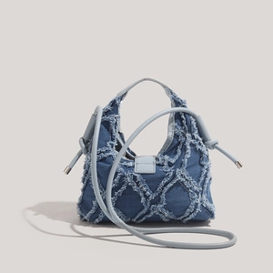 Denim star crossbody bag in blue with raw fringe and quilted diamond pattern