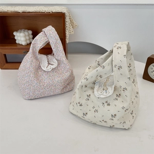 Close-up of floral canvas tote bags with delicate lace trim detailing for women
