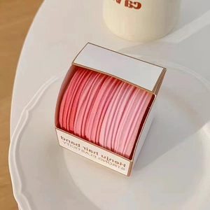 Pink gradient seamless hair bands set in a ceramic tray for high elasticity ponytails