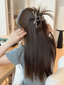 Lifestyle shot of large leopard print acrylic hair claw clip styling thick hair
