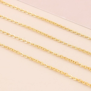 Detailed macro view of interlocking gold O-chain links with a polished metallic finish