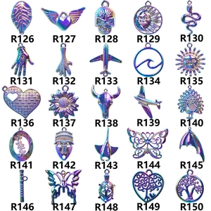 Macro view of 25 colorful metallic pendant charms including butterfly and heart shapes