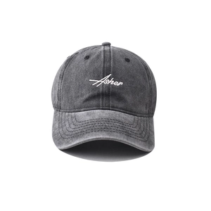 Detail of vintage washed denim baseball cap with white Asher embroidery and stitching