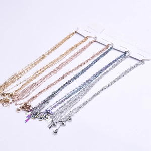 Detailed view of stainless steel cross link chains in gold, rose gold and silver finishes