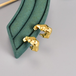 Minimalist irregular lava fold earrings in golden metal finish on velvet stand