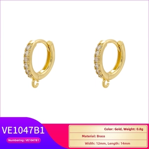 Detailed view of gold plated brass hoop earrings with single row diamonds and hanging loop