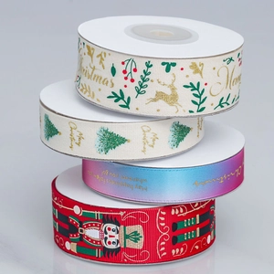Detailed view of four stacked Christmas ribbons with festive patterns for gift wrapping