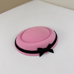 Elegant pink wool fascinator pillbox hat with black velvet ribbon and bow detail