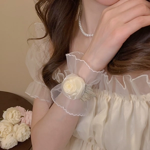 Gros plan sur le bracelet élégant en résille avec rose blanche et dentelle délicate