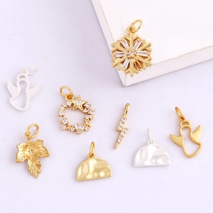 Detailed collection of gold and silver charms featuring snowflake, star, and maple leaf designs