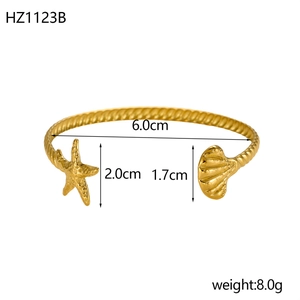 Detailed view of gold starfish and shell open bangle with dimensions and weight info