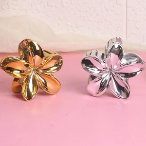 Elegant gold and silver flower hair claw clips in a minimalist metal design