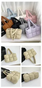 Multiple colors of quilted down tote bags featuring soft padded square stitching and handles
