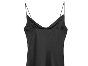 Detailed close-up of the black satin dress featuring delicate floral lace trim along the edge
