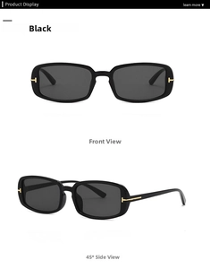 Detail of rectangular black sunglasses with iconic gold T-shaped metal hinge accents