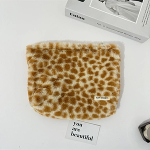Detail of soft faux fur makeup bag with giraffe pattern and premium zipper closure