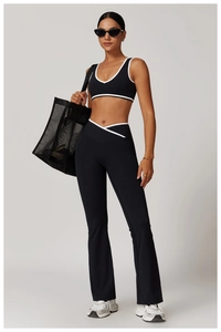 Detail of high-waist crossover yoga pants and v-neck sports bra with white trim
