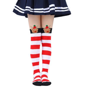 Close-up of red and white striped Christmas socks with a cute reindeer 3D doll ornament
