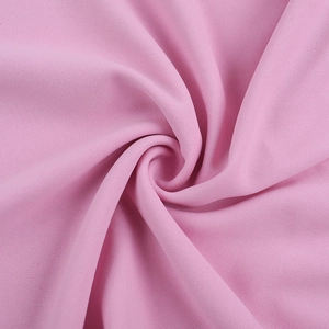 Detailed macro view of pink chiffon fabric texture with elegant pleated folds and shadows