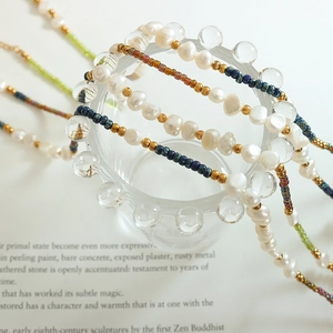 Bohemian freshwater pearl and natural stone titanium steel necklace on glass holder