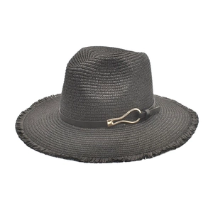 Detail of black straw fedora showing woven texture, frayed brim and gold buckle strap