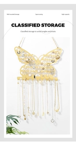Detail of golden butterfly wall jewelry rack showing necklace hooks and earring storage
