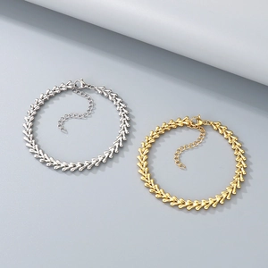 Close-up of adjustable wheat chain bracelets in gold and silver finishes with lobster clasp