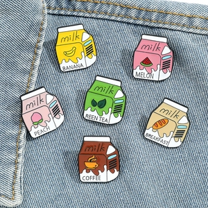 Set of 6 colorful enamel milk box pins displayed on a blue denim jacket pocket