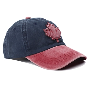 Macro detail of washed cotton baseball cap with maple leaf patch and distressed brim edges